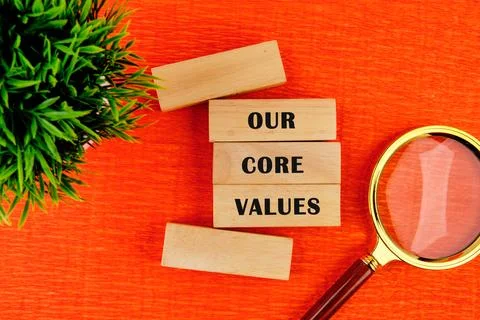 Concept words OUR CORE VALUES symbol on wooden blocks. Bright orange backgrou 写真素材