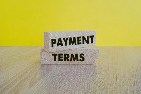 Concept words Payment terms on brick blocks. Beautiful yellow background Foto stock