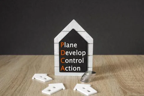 Concept words PDCA, plan develop control action on black blackboard. Stock Photos
