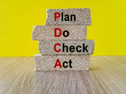 Concept words PDCA Plan, Do, Check, Act as eye-catching image on brick blocks Stock Photos