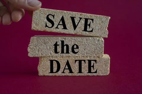 Concept words SAVE THE DATE on brick blocks. Beautiful pink background. Foto stock