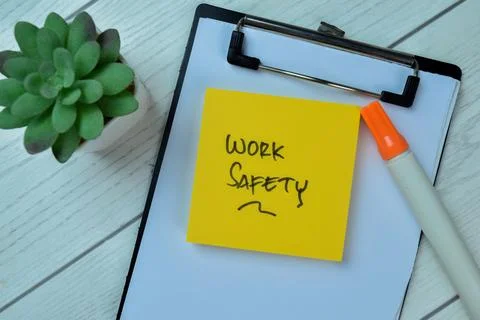 Concept of Work Safety write on sticky notes isolated on Wooden Table. Foto stock