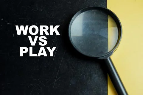 Concept of work vs play write on color background with magnifying glass. Stock Photos