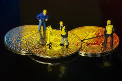 Concept of workers mining bit coin miniature people macro Stock Photos