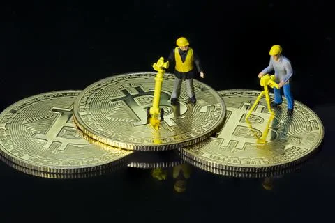 Concept of workers mining bit coin miniature people macro Stock Photos