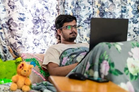 Concept of working from home. Middle-Class Asian Male leaning against the win Stock Photos