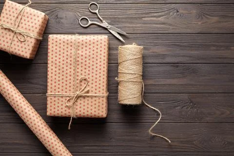The concept of wrapping gifts in rustic style on birthday or holidays. Dark Stock Photos