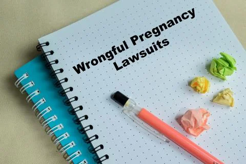 Concept of wrongful pregnancy lawsuits write on book isolated on Wooden Table 스톡 사진