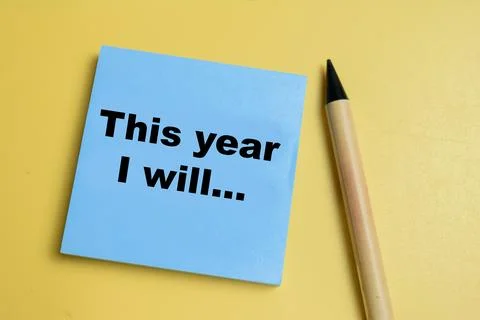 Concept of this year I will write on sticky notes isolated on table. Stock Photos