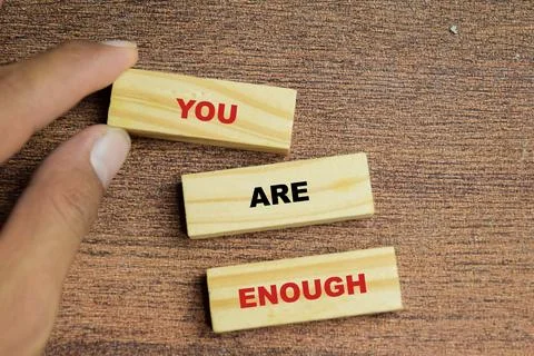 Concept of you are enough text on wooden blocks. Stock Photos