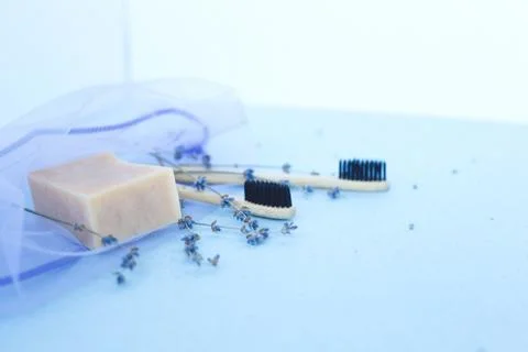 The concept of zero waste. bamboo toothbrushes in a reusable bag with lavender Stock Photos