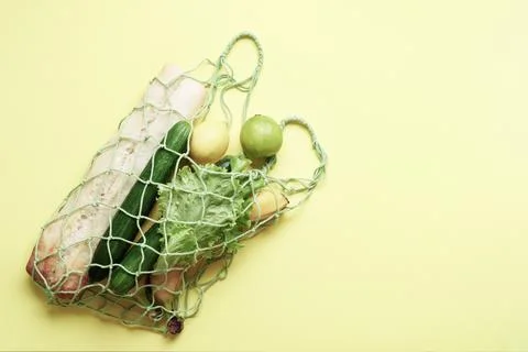 Concept of zero waste, environmental friendly products in a net bag on a blan Stock Photos