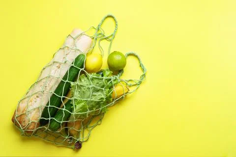 Concept of zero waste, environmental friendly products in a net bag on a blan Stock Photos