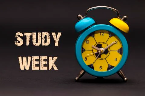 Concept,alarm clock with study week phrase written on black background Illustrazione stock