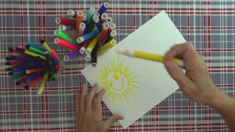 Concept.Drawing a red arrow on paper that has a drawing of a happy yellow sun Stock Footage 130538754