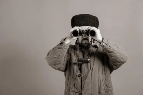 Conception - soldier on the post. Observation with binoculars, uniforms of un Fotos Stock