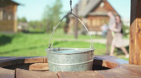Concepts and ideas Preservation of environment. Well. Bucket of clean water Stock Footage 69011764