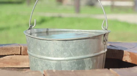 Concepts and ideas Preservation of environment. Well. Bucket of clean water Stock-Footage 69012691