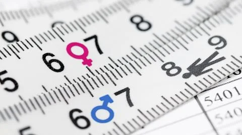 Concepts of gender equality. Close up view of measuring tape with symbol ge.. Stock Photos