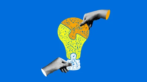 Concepts of innovation. Hands connect light bulb shaped puzzle Stock Footage 331216677