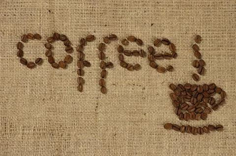 Conceptual artistic pattern of a cup of coffee made from coffee beans on a Foto stock