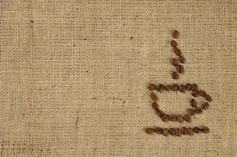Conceptual artistic pattern of a cup of coffee made from coffee beans on a Foto stock