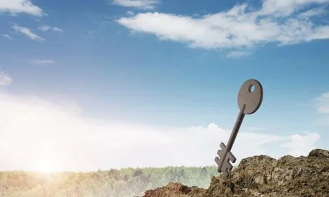 Conceptual background image of concrete key sign and natural landscape Stock Photos