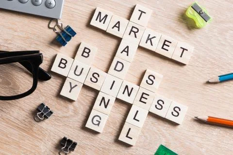 Conceptual business keywords on table with elements of game making crossword Stockfoto's