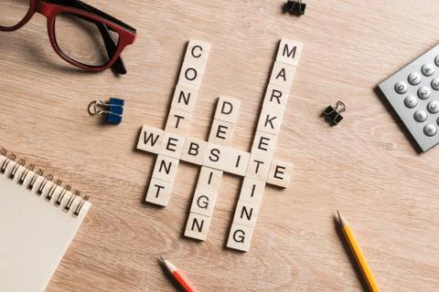 Conceptual business keywords on table with elements of game making crossword Stock Photos