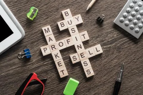 Conceptual business keywords on table with elements of game making crossword Foto stock