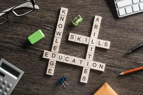 Conceptual business keywords on table with elements of game making crossword Stock Photos