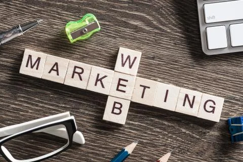 Conceptual business keywords on table with elements of game making crossword 库存照片