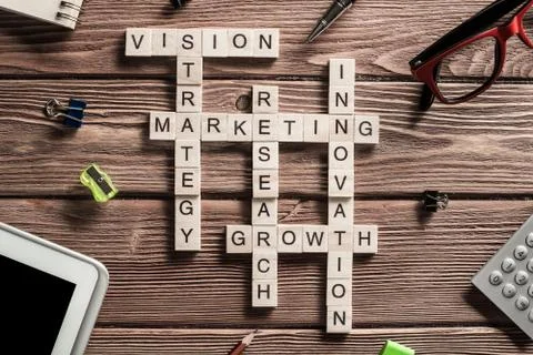 Conceptual business keywords on table with elements of game making crossword Stock Photos