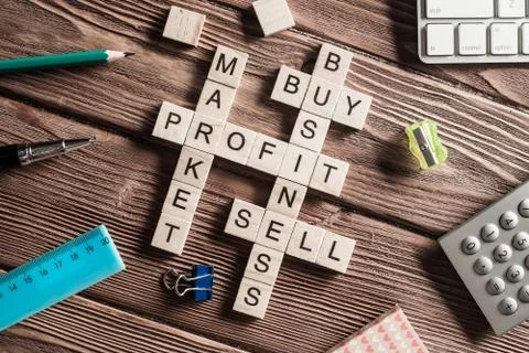 Conceptual business keywords on table with elements of game making crossword Stock Photos