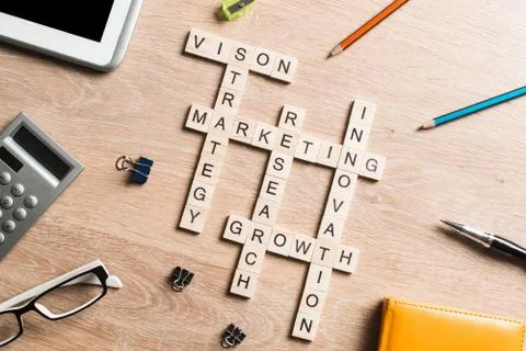 Conceptual business keywords on table with elements of game making crossword Stock Photos
