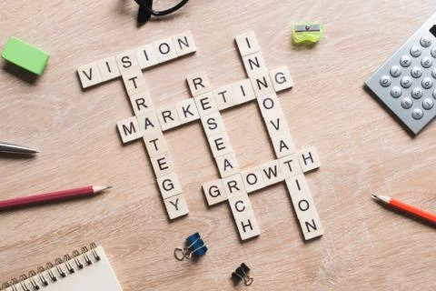 Conceptual business keywords on table with elements of game making crossword Stock Photos