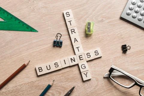 Conceptual business keywords on table with elements of game making crossword Stock Photos