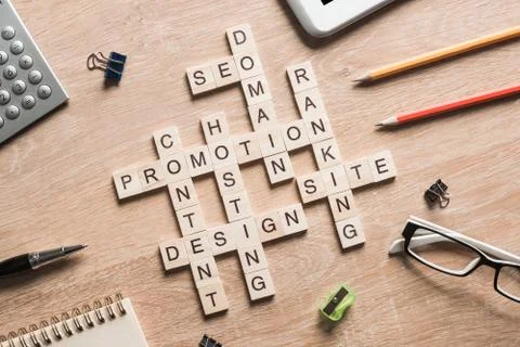 Conceptual business keywords on table with elements of game making crossword 写真素材