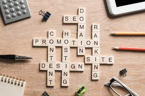Conceptual business keywords on table with elements of game making crossword Stock Photos