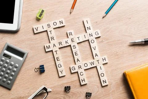 Conceptual business keywords on table with elements of game making crossword Stock Photos