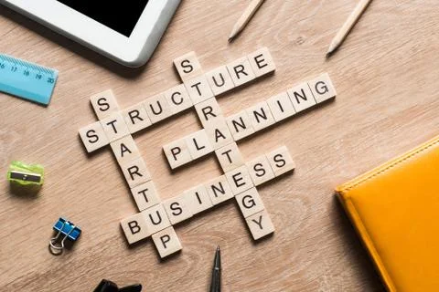 Conceptual business keywords on table with elements of game making crossword Stock Photos