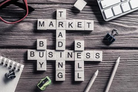 Conceptual business keywords on table with elements of game making crossword Stock Photos