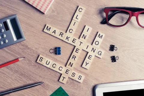 Conceptual business keywords on table with elements of game making crossword Stock Photos