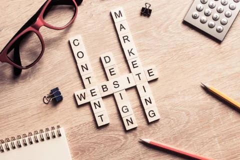 Conceptual business keywords on table with elements of game making crossword Stock Photos