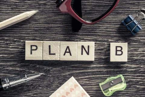 Conceptual business keywords on table with elements of game making words plan b Stock Photos