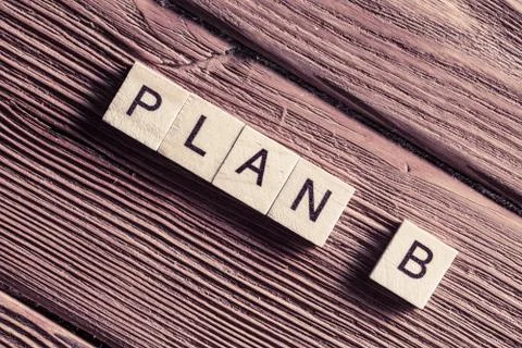 Conceptual business keywords on table with elements of game making words plan b Stock Photos