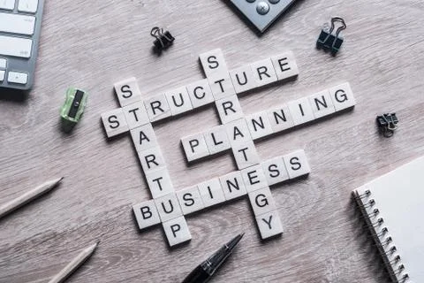 Conceptual business keywords on table with elements of game making crossword Foto stock