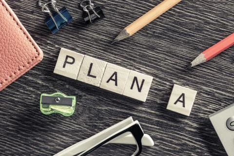 Conceptual business keywords on table with elements of game making words plan a Stock Photos