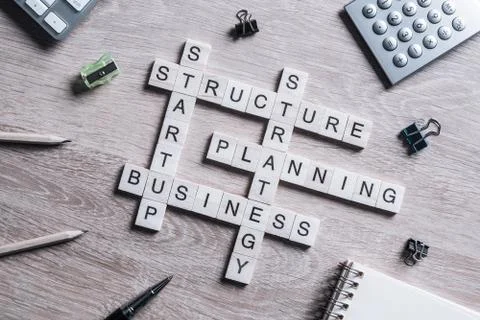 Conceptual business keywords on table with elements of game making crossword Stockfoto's