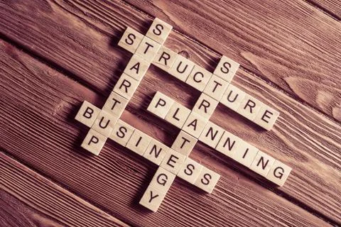 Conceptual business keywords on table with elements of game making crossword Stock Photos